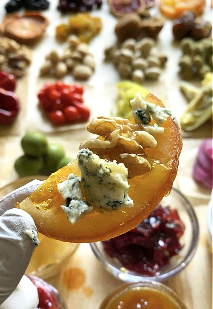 candied orange slice with blue cheese, walnuts, and dripping honey