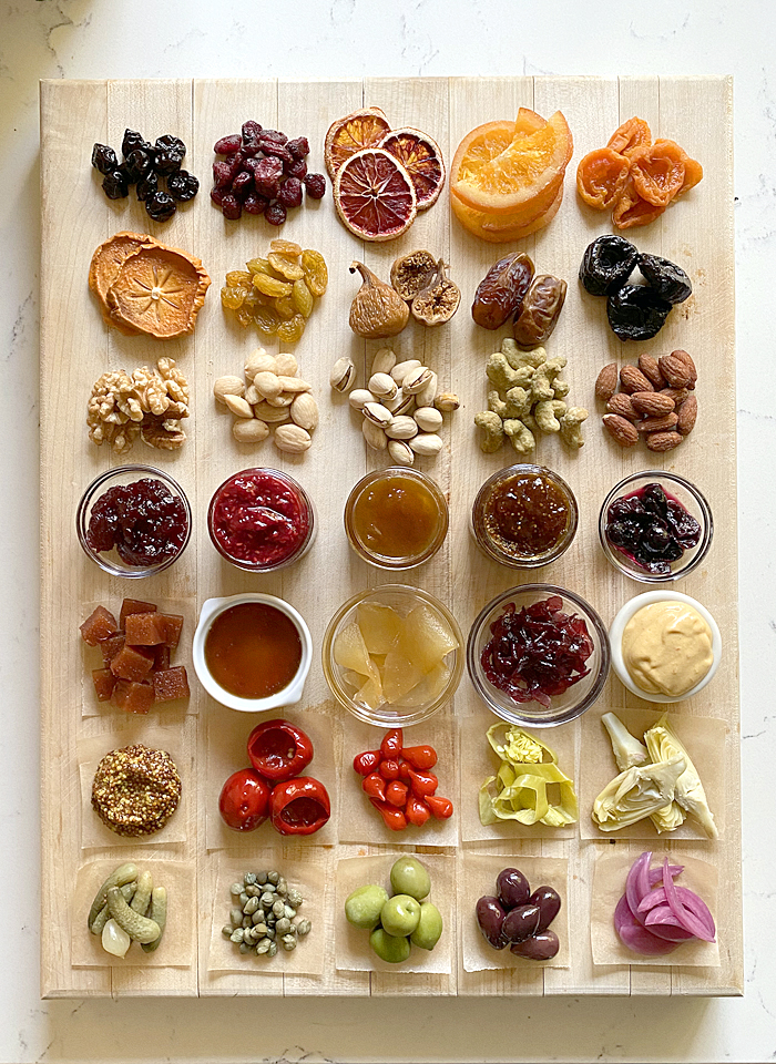 cheese board accompaniments displayed on cutting board