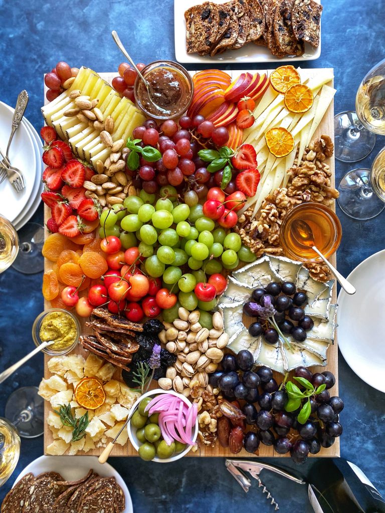 Cheese Board with red green and black grapes